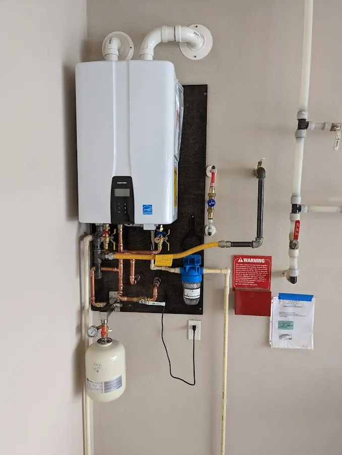 Professional plumber installing copper piping in a Elkton home